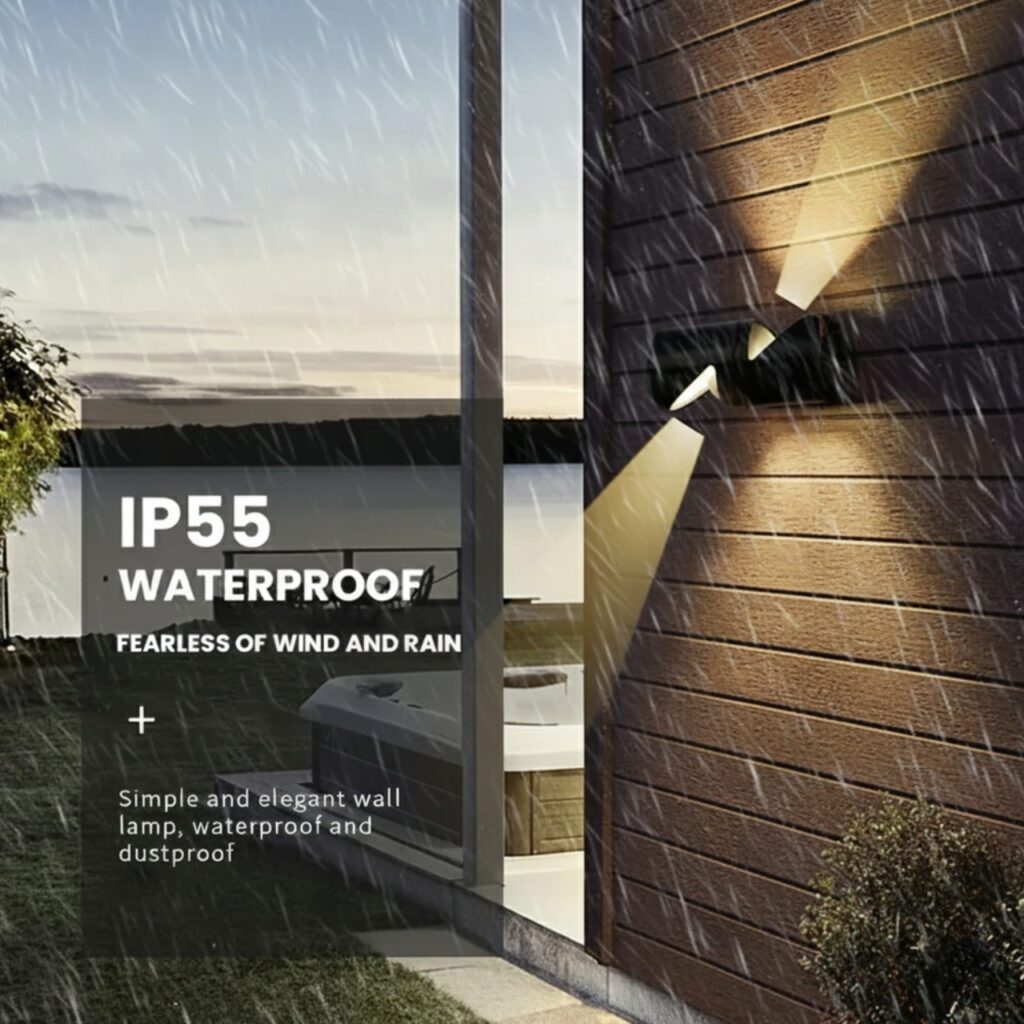 A modern black up-down wall light mounted on a gray wall, casting warm white light both upwards and downwards. The light is suitable for both indoor and outdoor use.