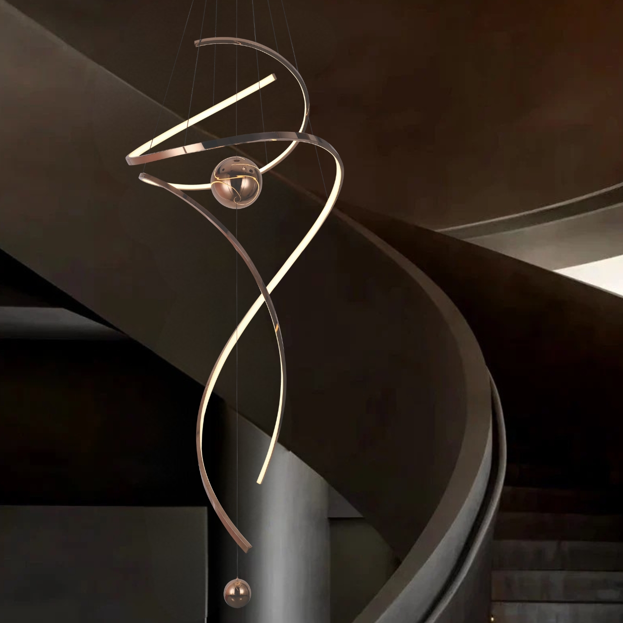 Modern spiral LED pendant light for high ceilings with metallic finish and spherical accents in a contemporary home foyer