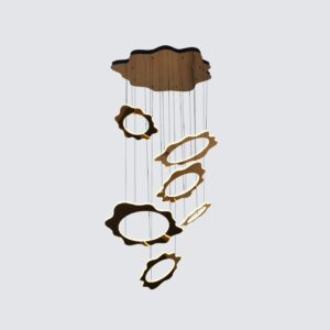 Modern gold LED chandelier in a high-ceiling luxury living room, illuminating a staircase and sofa with a warm glow.