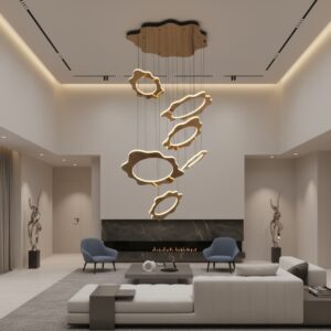 Modern gold LED chandelier in a high-ceiling luxury living room, illuminating a staircase and sofa with a warm glow.